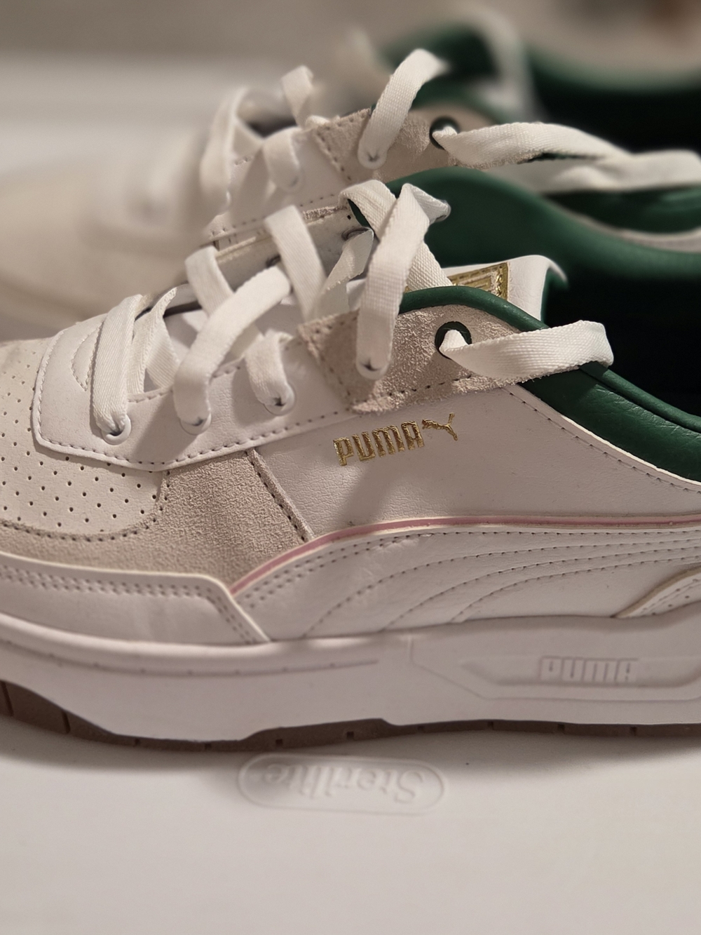 Puma White Sneakers with Green Trim and Gold Logo